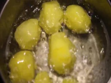 Kaynar suda soyulmuş patates. Sıcak atmosferde akşam yemeği aile yemeği pişirmek. Yüksek kaliteli HD görüntüler