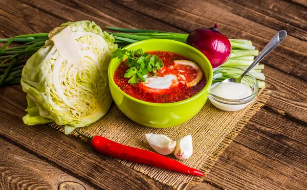 Ukrainian beetroot soup - borscht, on napkin, on wooden backgrou — Stock Photo, Image