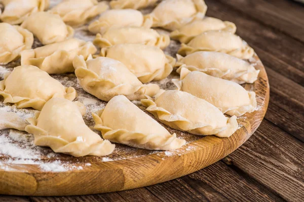 Pierogy, Masa, ahşap bir masaya yapma kesme heykeltraşlık. — Stok fotoğraf