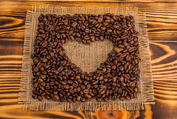 Coffee cup surrounded by toasted beans