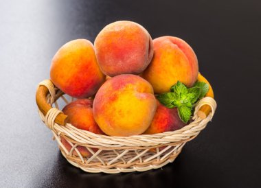 olgun şeftali ve yapraklar masada