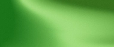 Parlak yeşil desenli yüzey, sol üstten sağ alta doğru çapraz bir yönde parlayan ışık yansıması ile ince bir gradyan etkisi ile görsel olarak soyut bir arka plan oluşturur..