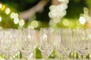 Row of wine glasses in green background clipart