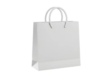 Bu resim, ayakta duran basit, boş beyaz bir alışveriş torbasını gösteriyor. Torbanın üstünde iki tane sağlam tutacağı var. Bakkaliye, perakende alışverişler veya diğer eşyalar için uygun. Logo ve parmak izi olmayan temiz ve minimalist bir tasarım içeriyor, maki.