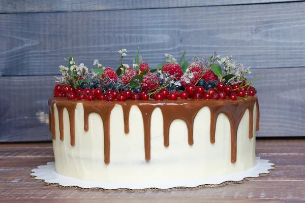 Delicious chocolate color drip cake with berries