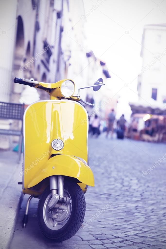 yellow Italian production motorcycle parked in the city