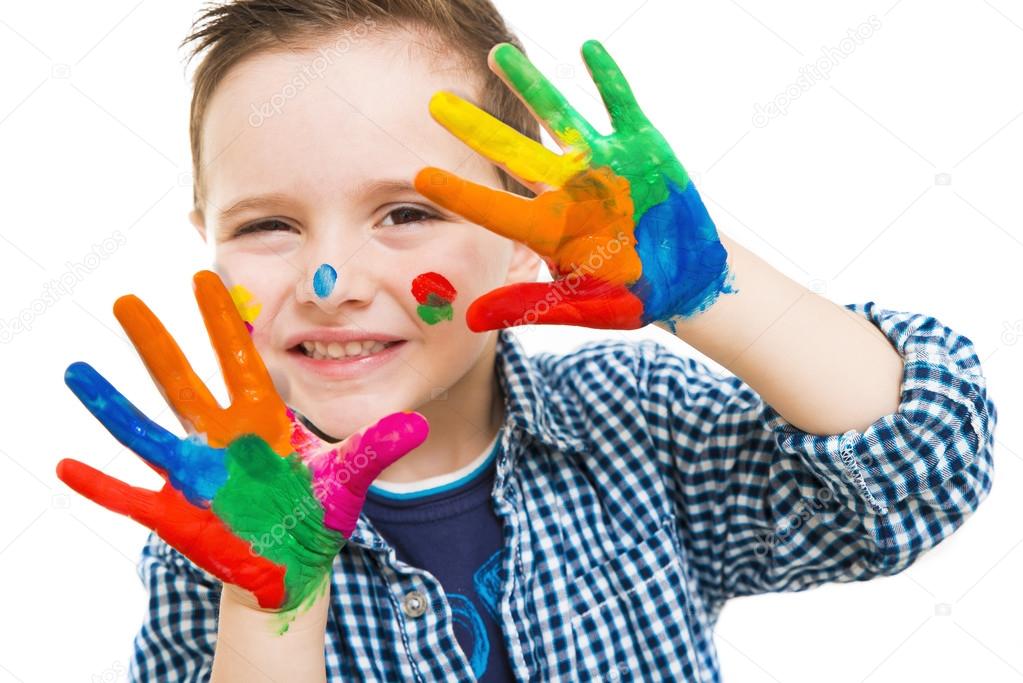 happy child with their hands all painted playing