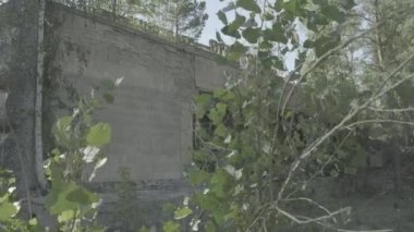 Camera slides to reveal the derelict Prometey cinema in Pripyat, Chernobyl. Ungraded Log Footage