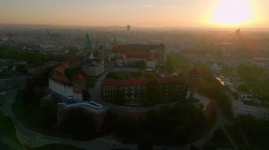 İnsansız hava aracı, muhteşem bir yaz gündoğumu sırasında Polonya 'nın Krakow kentindeki Wawel Kalesi' nin etrafında dönüyor. Arka planda eski kasaba var.