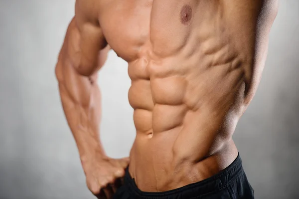 Strong athletic man fitness model showing six pack abs — Stock Photo, Image