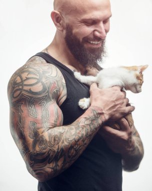 Vahşi, sakallı, kedisi soyutlanmış beyaz arka planı olan bir adam.