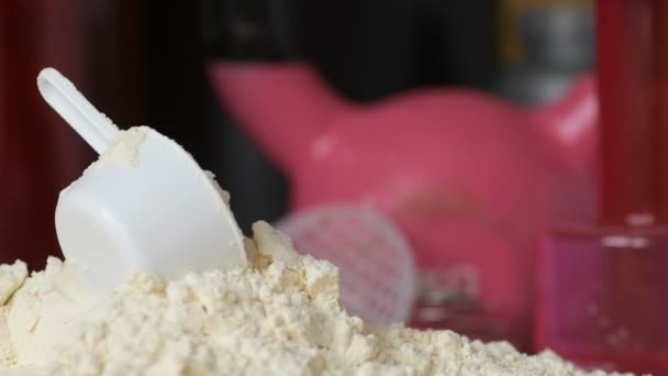 Protein Tozu Ölçüm Kepçesi Kavanozun Üzerinde Sallanan Şişe Arka Planında — Stok video