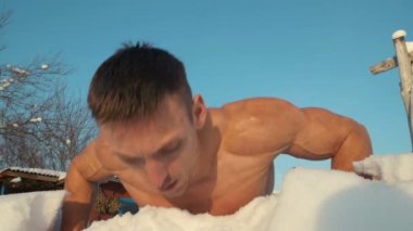 Spor salonundaki adam çıplak bir gövdeyle spor yapıyor. Kışın açık havada şınav. Spor, sağlık ve sertleşme kavramı  