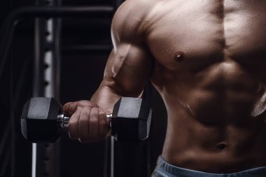 Spor salonundaki atletik adamın vücudunu kapatın. Vücut geliştirme, fitness ve spor konsepti