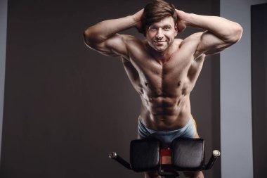 Kafkasyalı atletik adam kaslarını çalıştırıyor. Güçlü vücut geliştirici, karın kasları mükemmel. Spor ve spor konsepti