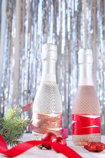 Arkadaki tahta kutuda bir şişe beyaz şarap Noel ağacı ve hediyeli bir bardak.