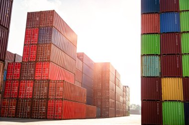 Yeşil konteynırların yanında büyük bir kırmızı konteynır yığını var. Kırmızı kaplar yeşillerden daha uzun.