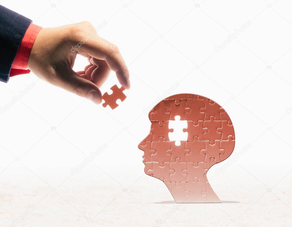 Human head shape puzzle and missing puzzle piece. Mental health concept.