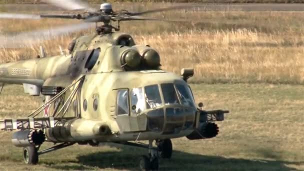 Wind shot Military helicopter landing on battlefield — Stock Video