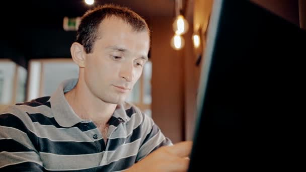 Bilgisayar ve içecek kahve kafede üzerinde çalışan orta çekim adam — Stok video