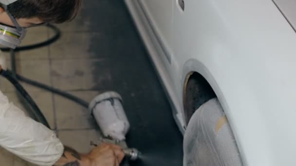 Mid shot Worker paints a car in white colour — Stock Video