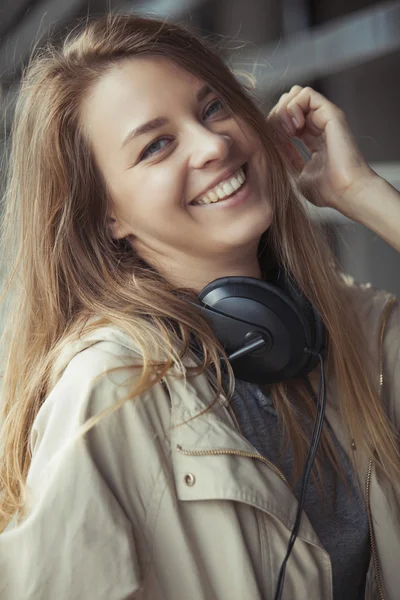 Дівчина з навушниками посміхається чарівна — стокове фото