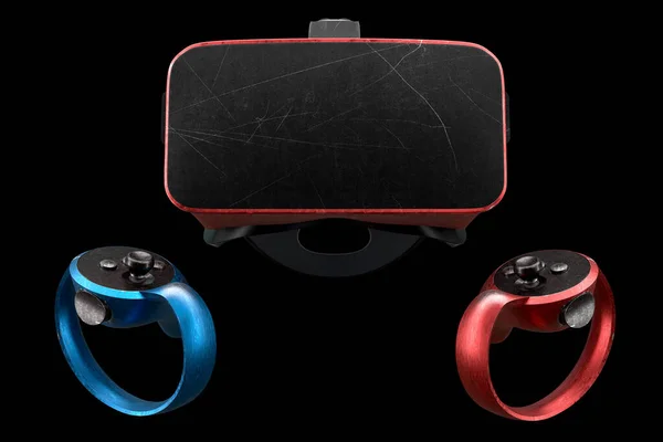 Used virtual reality glasses and controllers with scratches for online and cloud gaming isolated on black background. 3d rendering of goggles for AR, cybersport hardcore gaming and e-sport tournament