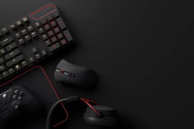 Oyun alanının üst görüntüsü ve fare, klavye, joystick, kulaklık, siyah masa arka planında VR kulaklık gibi teçhizatlar. Canlı yayın konsepti için aksesuarların 3D yorumlaması