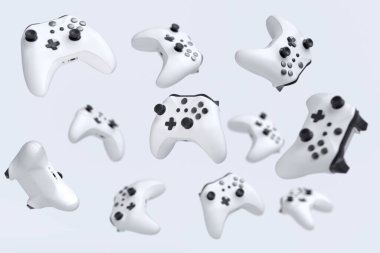 Uçan oyun joystickleri ya da beyaz arkaplanda oyun yastıkları