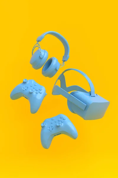 Flying gamer gears like VR glasses, headphones and joystick on yellow background — Stock Photo, Image