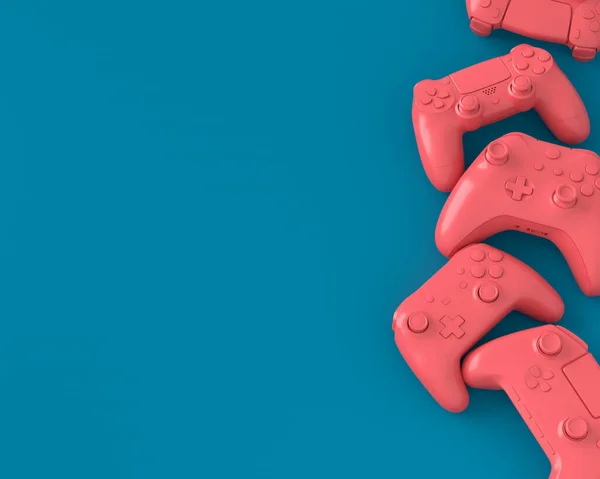 Juego de joysticks o gamepads mentirosos sobre fondo azul y rosa —  Fotos de Stock
