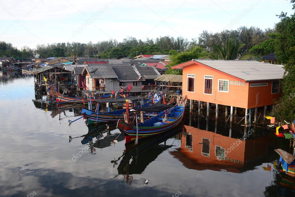 NARATHIWAT, THAILAND 1 JANUARY 2021 : Local fishing village along the Bang Nara River with kolae boats colorful