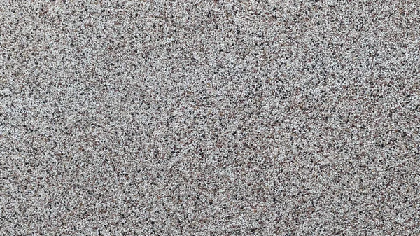 Çeşitli projeler için ideal gri kum dokusunun yakın plan görüntüsü.
