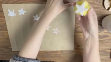 Kadın el işi kağıtlarını patatesle süslüyor..