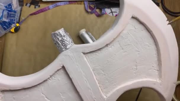 Womens hands show styrofoam Celtic axe. — Stock Video