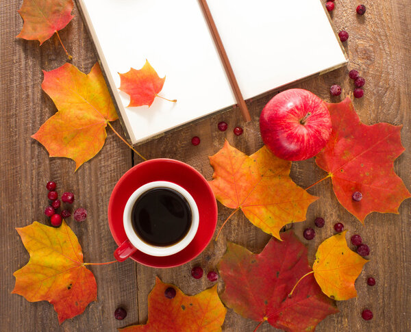 Autumn still-life. The coffee Cup, Notepad, apples, knitting, autumn leaves