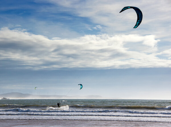 The single Kite surfer  glide on the waves of the Atlantic ocean