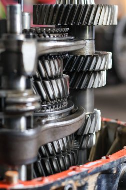 Parçalanmış bir araçtan gelen sarmal dişli ve şaftların detaylı yığını bileşenlerin mekanik karmaşıklığını ve hassas mühendisliğini gözler önüne seriyor..