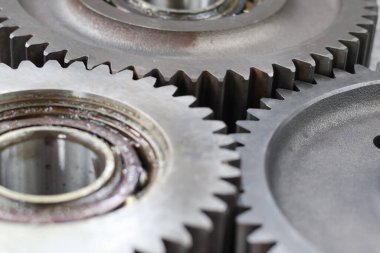 Metalik doku ve mekanik hassasiyet içeren birbirine kenetlenmiş çelik dişliler ve bilyelerin detaylı makrosu.