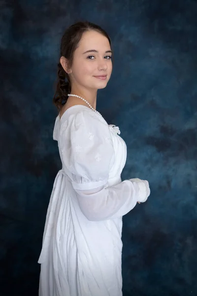 Young Regency Woman Standing Alone Blue Backdrop — Stock Photo, Image