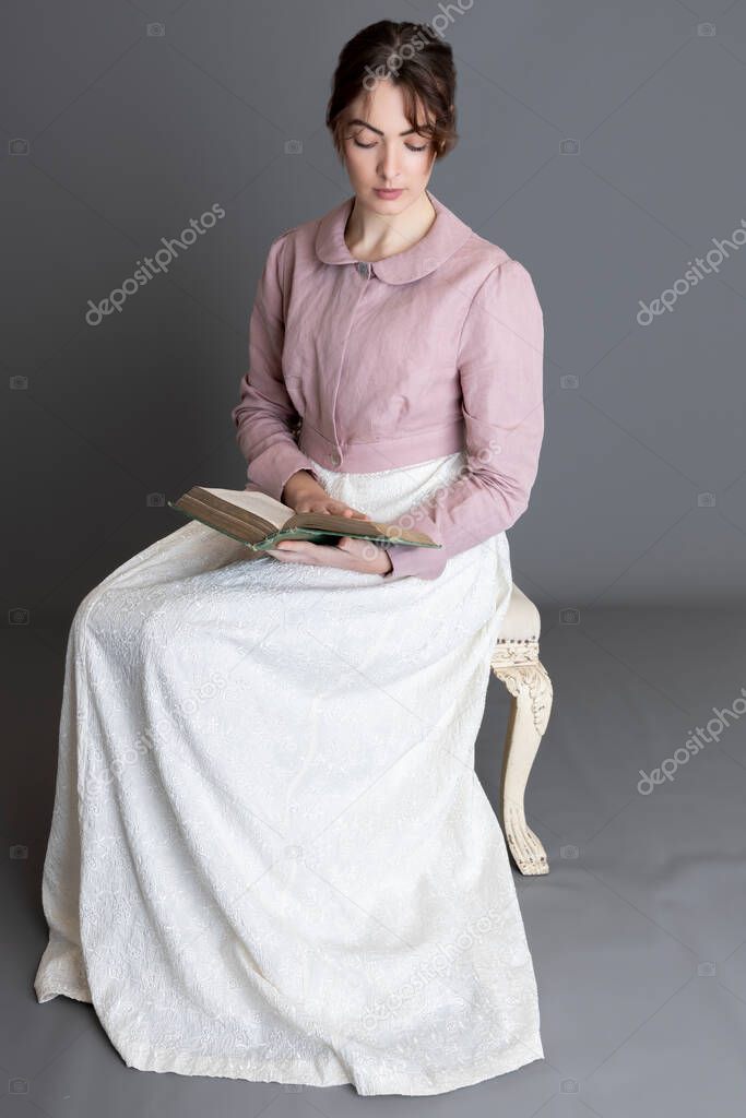 Regency woman wearing an embroidered cream dress and a pink linen spencer