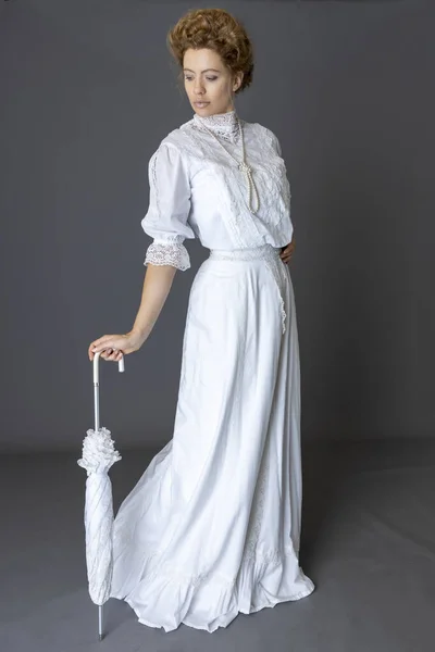長い真珠のネックレスとパラソルを持っている白いレースのブラウスとスカートを身に着けているエドワードの女性 — ストック写真