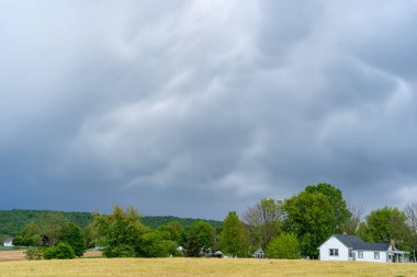Some dark stormy looking clouds over the landscape.