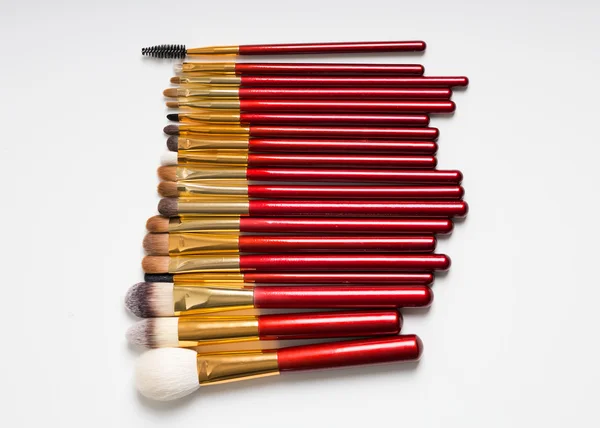 Flat lay. Makeup brushes on white background. top view