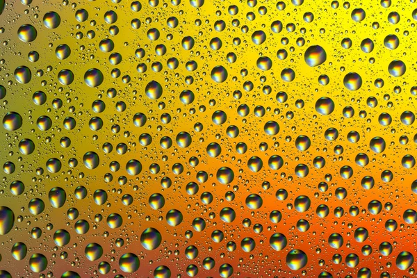 Drops of water on a colorful background — Stock Photo, Image
