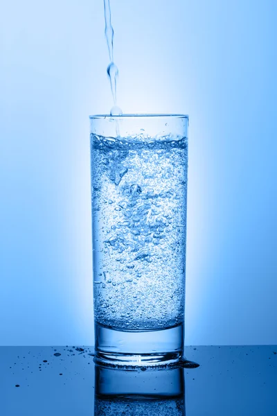 Mavi bir arka plan üzerinde su ile güzel cam