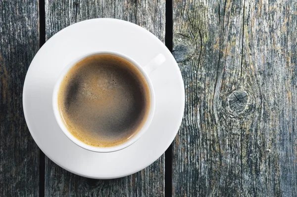 Cup of coffee on a wooden background — Stock Photo, Image