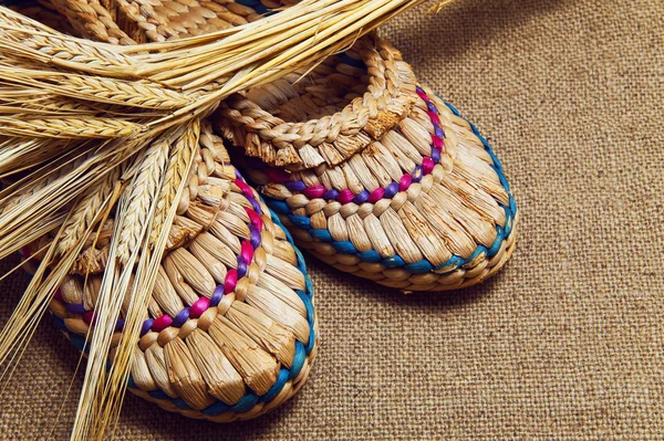 Sandals and rye on background of jute — Stock Photo, Image