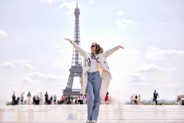 Happy tourist woman enjoying view of Eiffel Tower in Paris