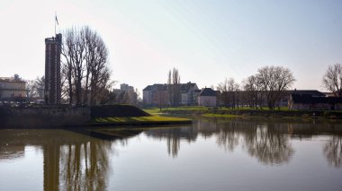 Su yansımaları ve tarihi binaları olan huzurlu şehir manzarası Chalon sur Saone